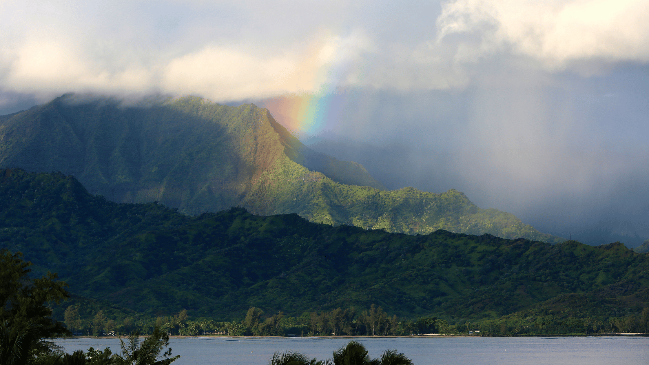 a large body of water with a mountain in the background