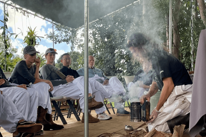 a group of people sitting around a fire
