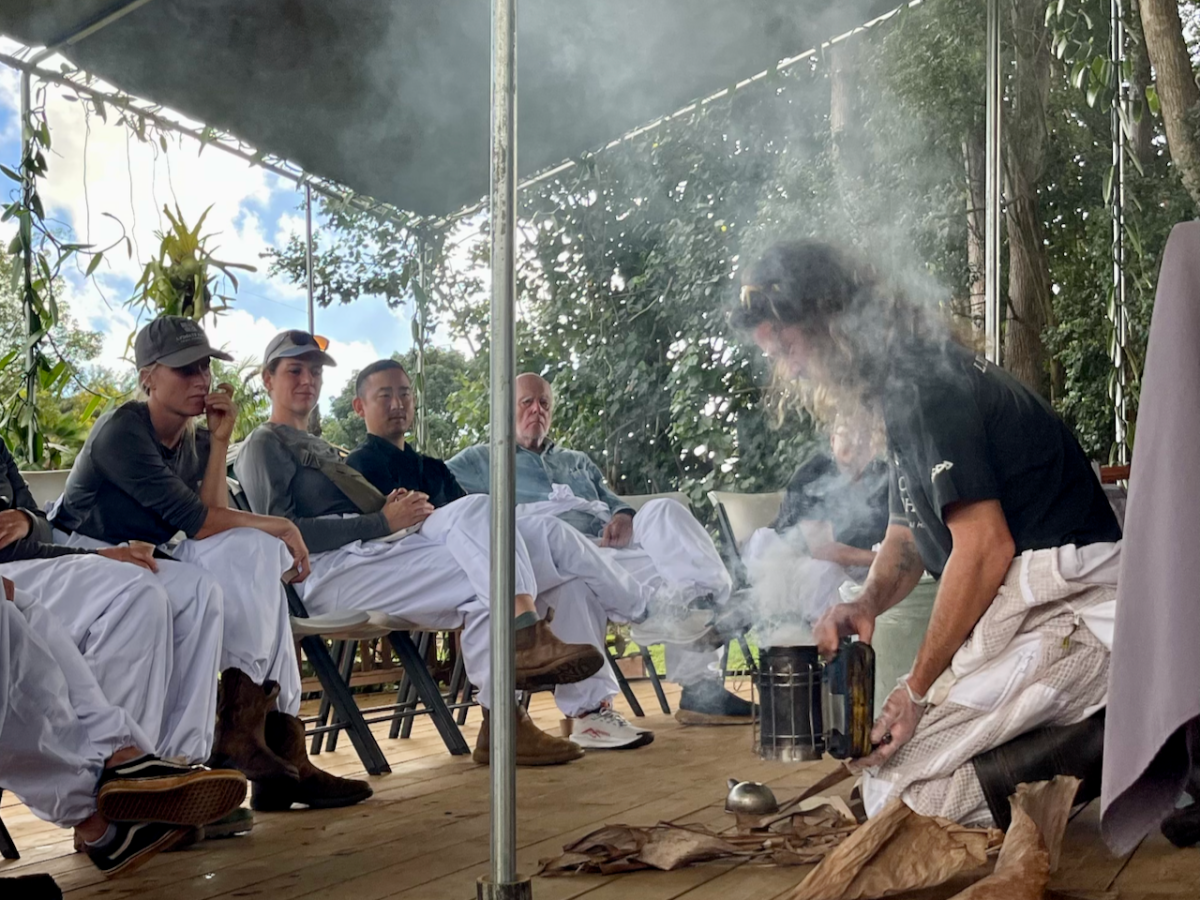 a group of people sitting around a fire